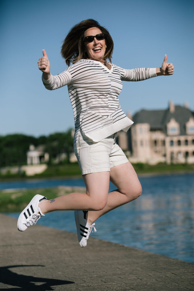 Woman Jumping for Joy in White Shorts