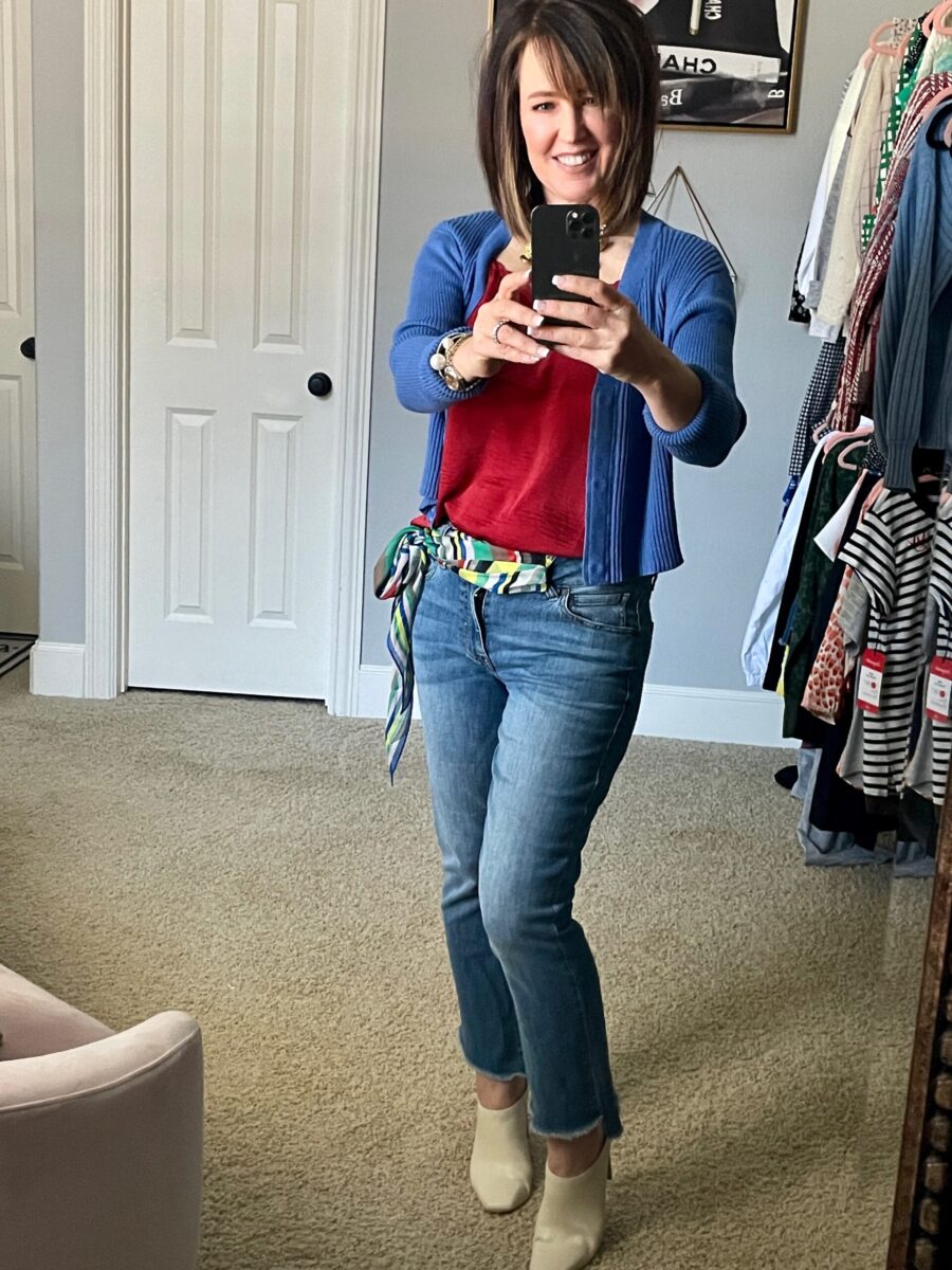 A woman taking a selfie in front of the mirror.