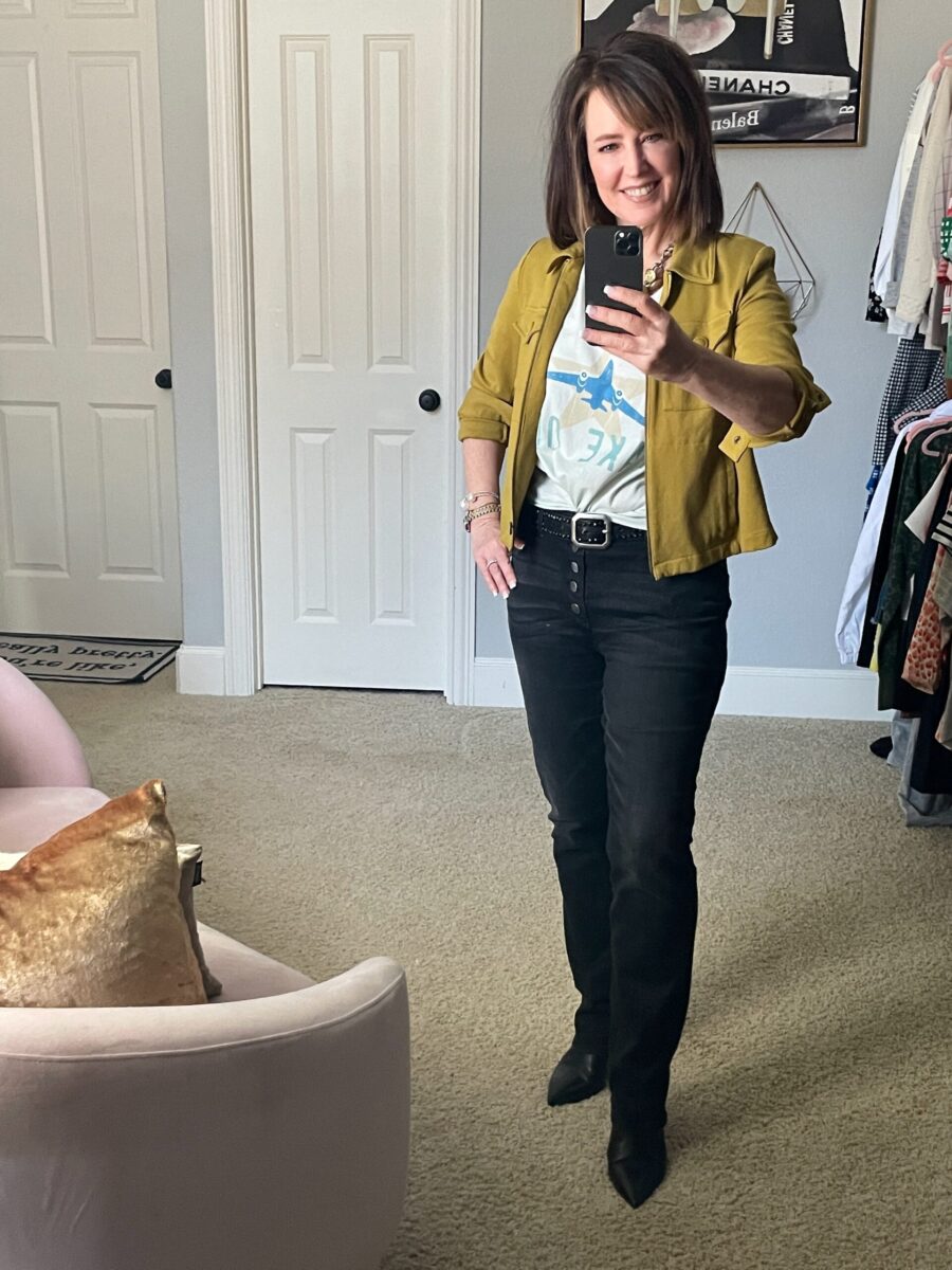 A woman taking a selfie in front of the mirror.